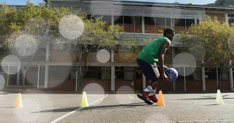 Athlete practicing basketball dribbling drill outdoors