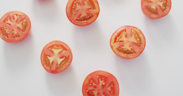 Image of fresh halved red tomatoes on white background. fusion food, fresh vegetables and healthy eating concept.