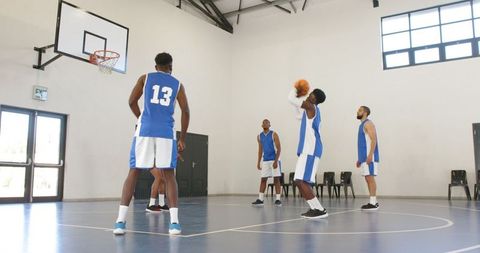 Basketball Team Standing around Shooter During Free Throw
