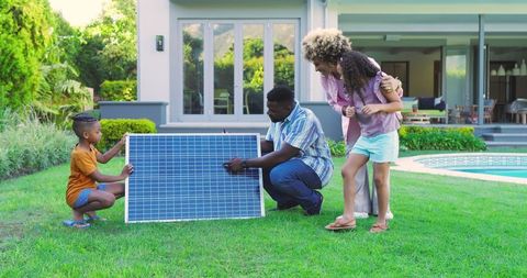 Family Assembling Solar Panel in Yard for Sustainable Living