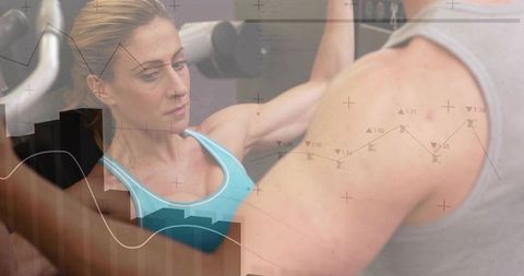 Woman pressing chest press while trainer spotting with data overlay fitness strength tech