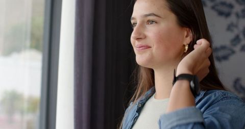 Woman Contemplating by Window in Cozy Apartment