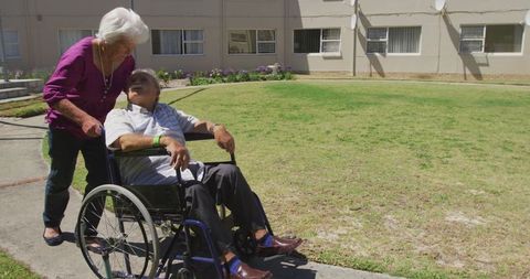 Elderly Couple Enjoying Stroll at Retirement Home Garden