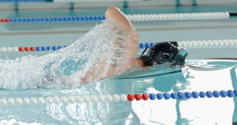 Male Athlete Freestyle Swimming in Pool for Athletic Training