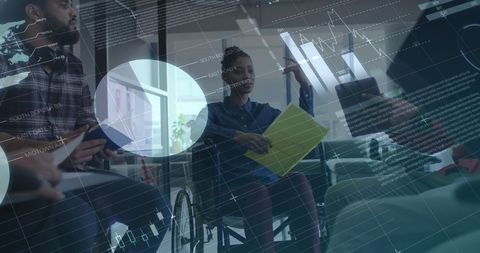Businesswoman in Wheelchair Leading Team Meeting with Data Overlay