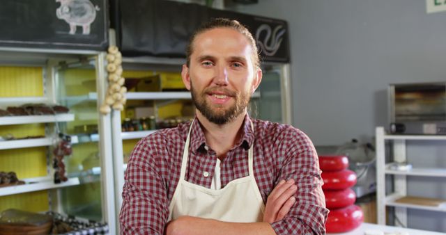 Confident Shopkeeper in Butcher Shop Wearing Checkered Shirt and Apron - Download Free Stock Images Pikwizard.com