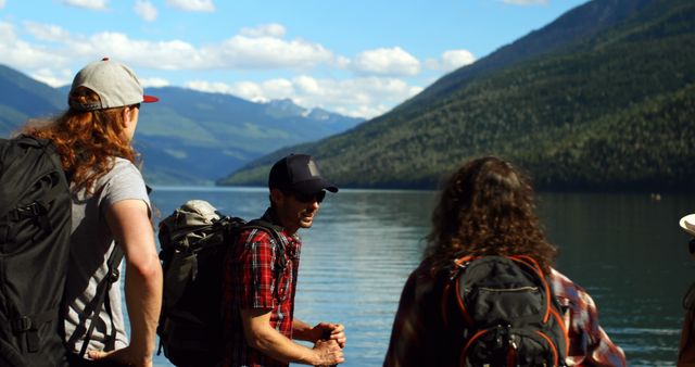 Group of backpackers hiking near mountain lake on sunny day - Download Free Stock Images Pikwizard.com