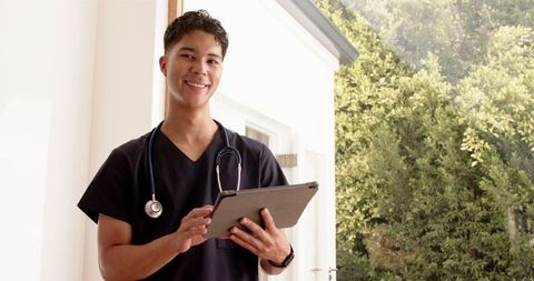 Healthcare Professional Using Tablet with Stethoscope Outdoors