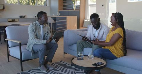 African american couple meeting real estate agent in modern home