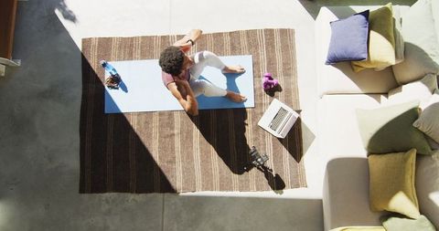 Fit Man Doing Home Workout Boswellness with Laptop Presence
