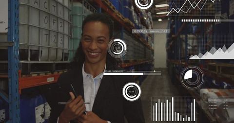 Smiling warehouse worker analyzing data with digital interfaces