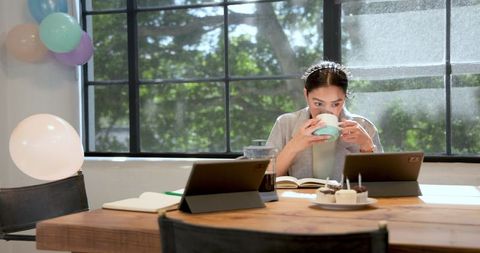 Employee enjoying office party in decorated workspace