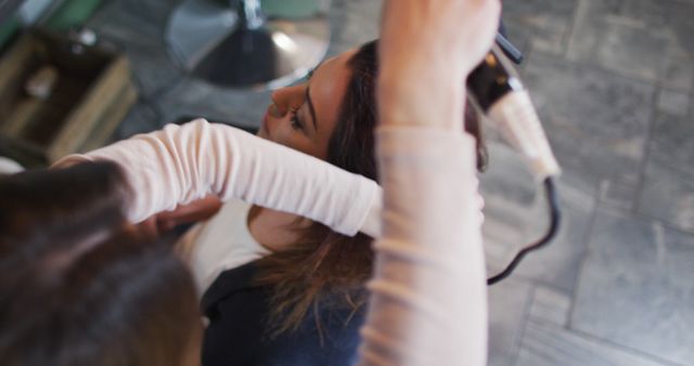 Hairdresser Styling Customer's Hair with Curling Iron - Download Free Stock Images Pikwizard.com