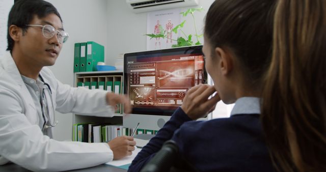 Doctor Explaining Medical Results to Young Female Patient on Computer - Download Free Stock Images Pikwizard.com