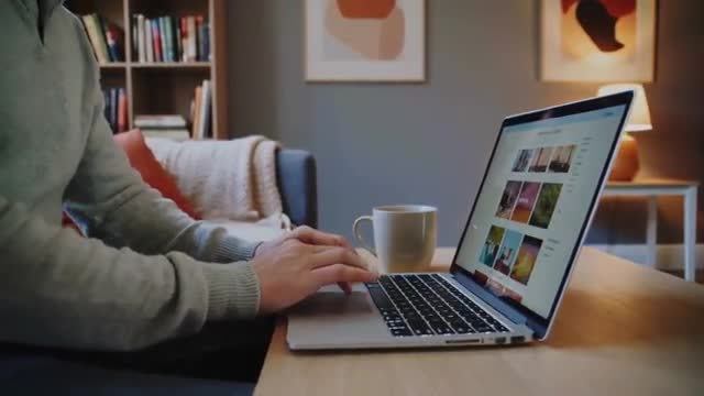 Typing and Navigating a Laptop at Cozy Home Workspace