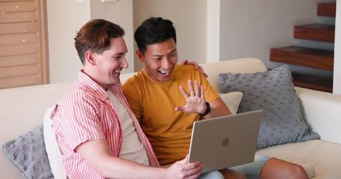 Diverse Couple Enjoying Online Video Call from Sofa