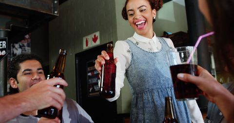 Friends Celebrating with Drinks in Lively Restaurant