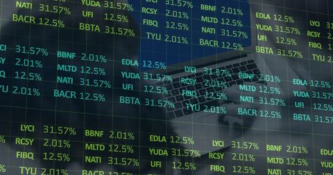 Digital stock market data overlay on laptop