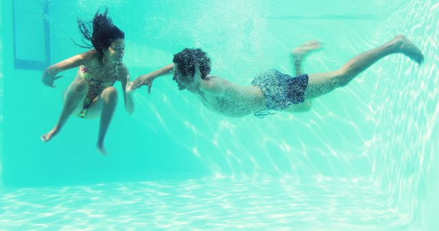 Children Enjoying Underwater Swim in Sunny Pool - Download Free Stock Images Pikwizard.com