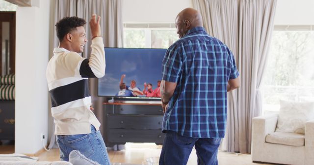 Father and son bonding while watching sports at home - Download Free Stock Images Pikwizard.com