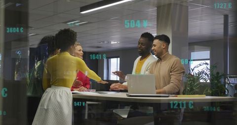 Diverse coworkers discussing strategy at standing table with laptop and teal data overlays