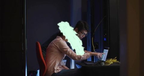 Av technicians collaborating backstage checking laptop and yellow network cables