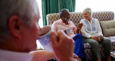 Elderly Friends Relaxing with Coffee in Warm Interior - Download Free Stock Images Pikwizard.com
