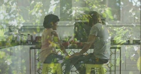 Romantic Couple Enjoying Coffee with Nature Overlay in Kitchen