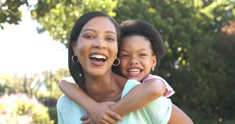 Joyful Mother Daughter Connection in Sunlit Garden Outdoors