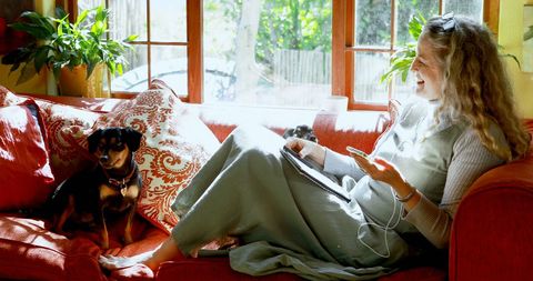 Relaxing Woman with Dog Embracing Cozy Home Vibes