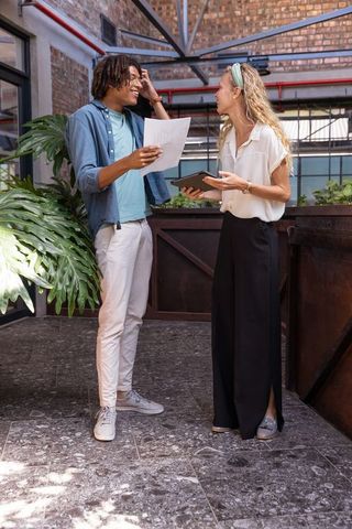 Coworkers engaged in discussion in modern coworking lounge
