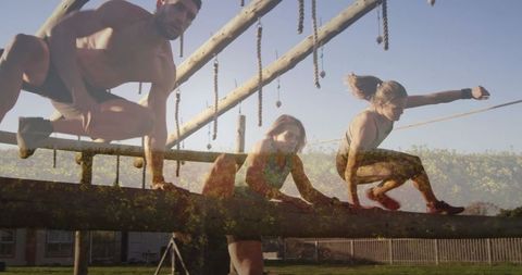 Team Navigating Outdoor Obstacle Course with Wooden Beams