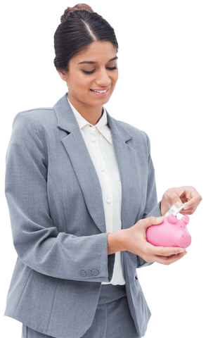 Smiling businesswoman filling transparent piggy bank