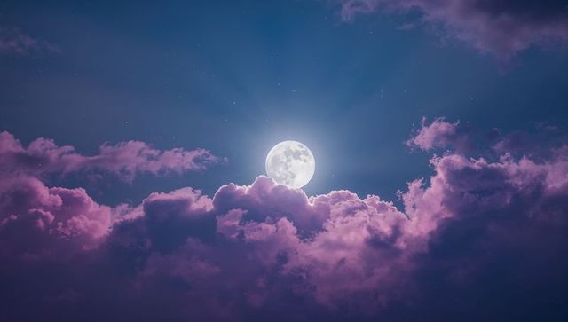 Moonlit Night with Pink Clouds and Stars in a Tranquil Sky