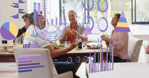 Multigenerational Friends Sharing Meal While Discussing Infographics Around Dining Table