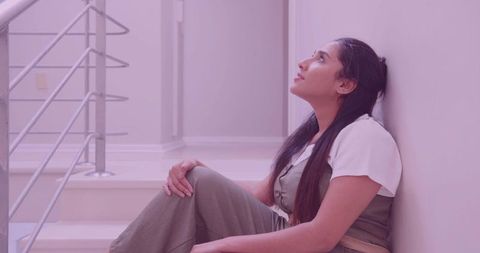 Contemplative Indian Woman Sitting on Modern Staircase