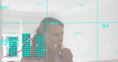 Mature woman applying lipstick at smart vanity mirror with digital gridlines and analytics