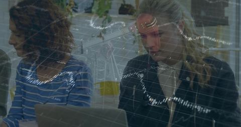 Colleagues analyzing budgets in modern open-plan office