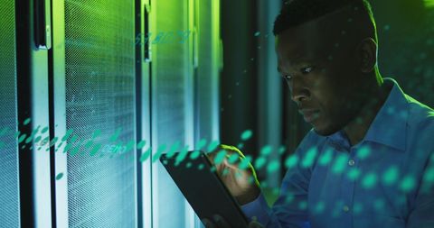 African american engineer using digital tablet in data server room
