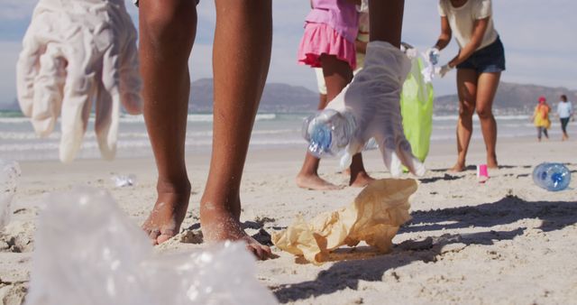 African american parents with two children wearing face masks collecting rubbish from the beach - Download Free Stock Photos Pikwizard.com