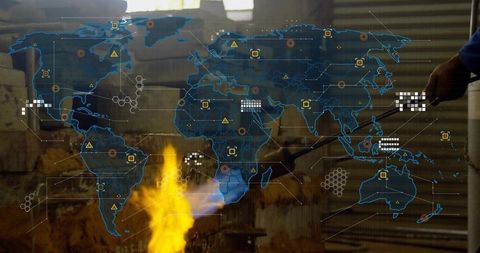 Craftsman with forge heating metal in workshop illuminated by holographic map