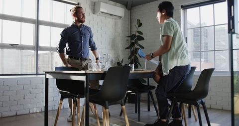Business Professionals Shaking Hands Sealing Successful Deal in Modern Office