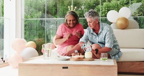 Senior Couple Celebrating Birthday with Cake and Crowns
