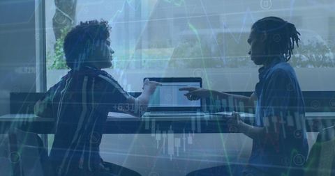 Two Professionals Working on Laptop Analyzing Financial Data