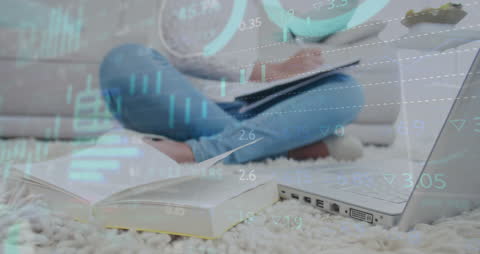 Woman Analyzing Financial Data with Laptop and Notebook