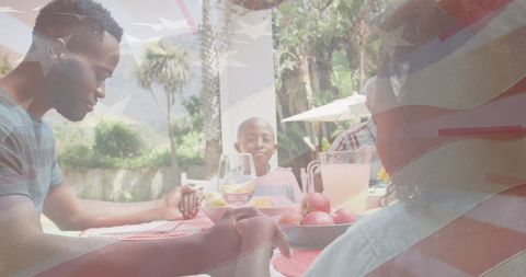 African American Family Enjoying Dinner with USA Flag Overlay