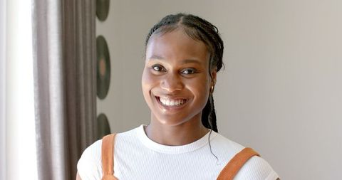 Joyful African American Woman Smiling at Home in Sunlit Room