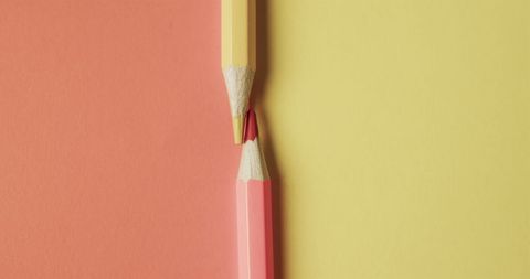 Close up of colorful pencil crayons on two-toned background