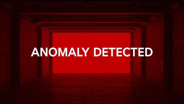 Anomaly detected warning in industrial garage with red backlight and concrete columns