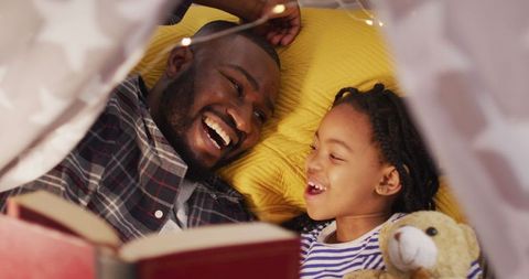 Father and Daughter Reading in Cozy Tent Fort